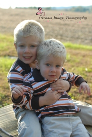 brothers posing by a cornfield