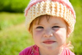 child with crocheted hat