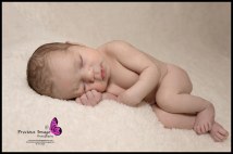 baby girl posed on white fluffy background